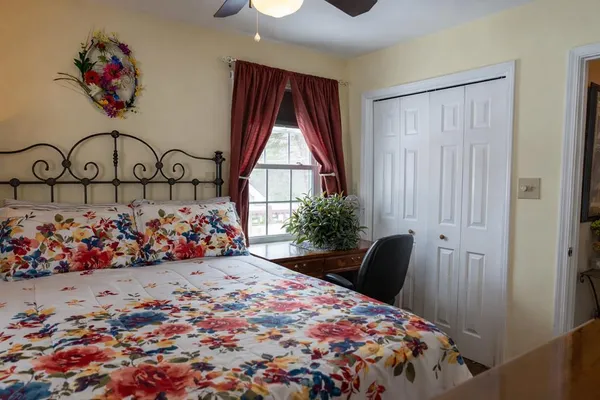 a bedroom with a bed and a chandelier