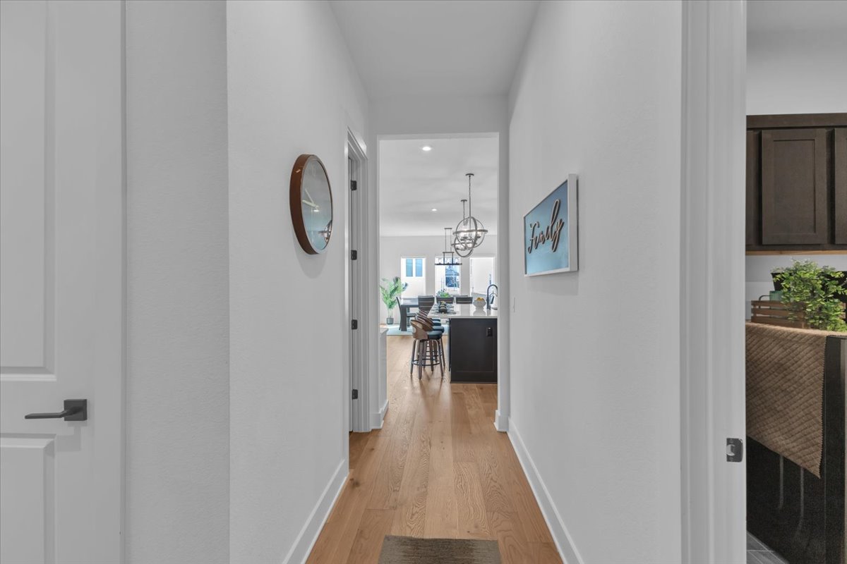 2312 Mondello Path Leander, TX 78641 - Photo 13 of 40 Hallway with light wood-style floors and suspended lighting