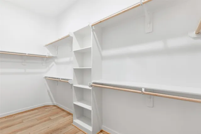 a spacious bathroom with a double vanity sink and a mirror