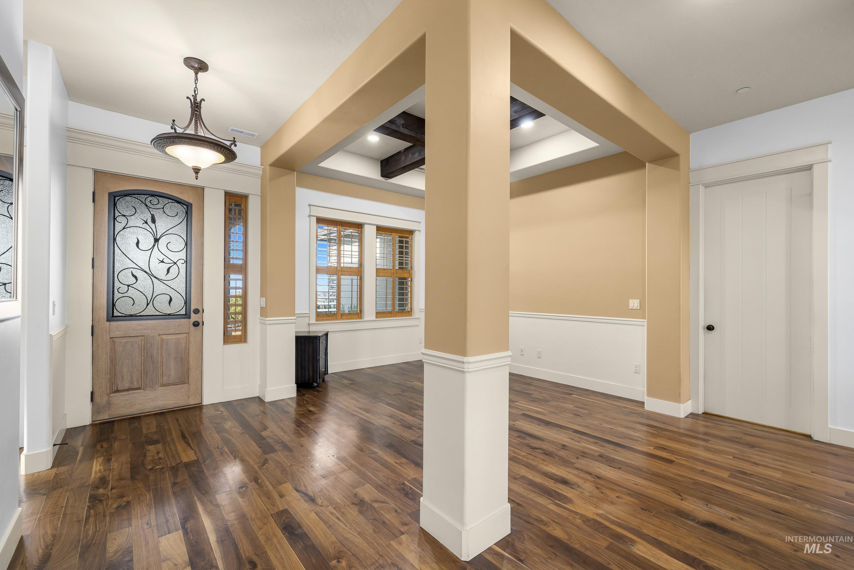 7521 North Grand Ridge Lane Eagle, ID 83616 - Photo 6 of 50 Foyer entrance with dark wood finished floors, beamed ceiling, and recessed lighting