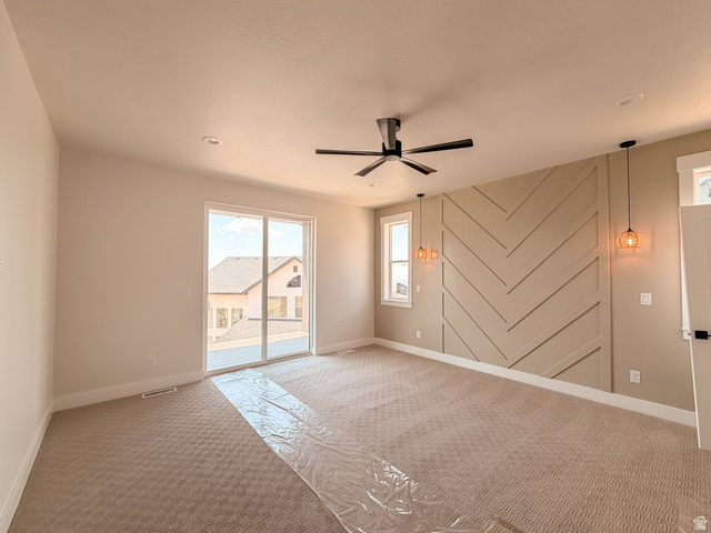 619 East Mountain Road North Ogden, UT 84414 - Photo 5 of 8 Spacious room featuring a decorative accent wall with a chevron pattern, a ceiling fan with integrated lighting, and recessed ceiling lights