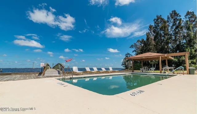 a view of a swimming pool with a yard