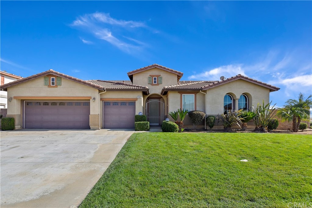 9598 Taft Street Riverside, CA 92508 - Photo 1 of 1 a front view of a house with a yard and garage