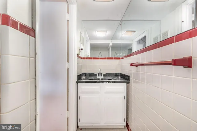 a kitchen with granite countertop a sink and a refrigerator