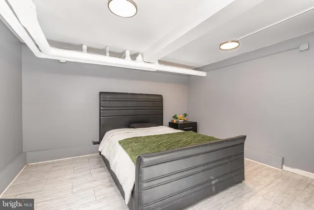 a bedroom with a bed and cabinet