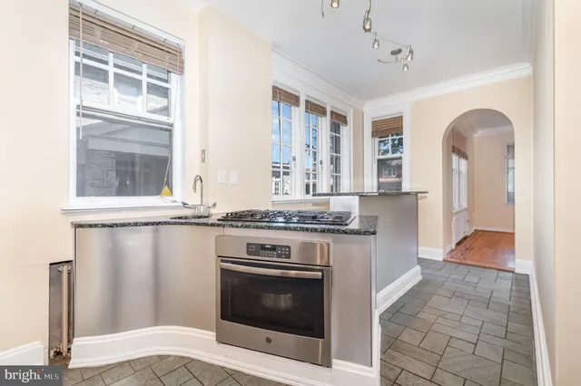 a kitchen with stainless steel appliances granite countertop a stove and a refrigerator