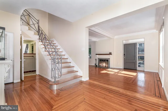 a view of a livingroom with wooden floor and staircase