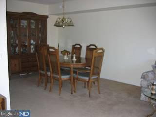 1209-17 Norwalk Road, Unit 11 Philadelphia, PA 19115 - Photo 2 of 5 a dining room with furniture and chandelier