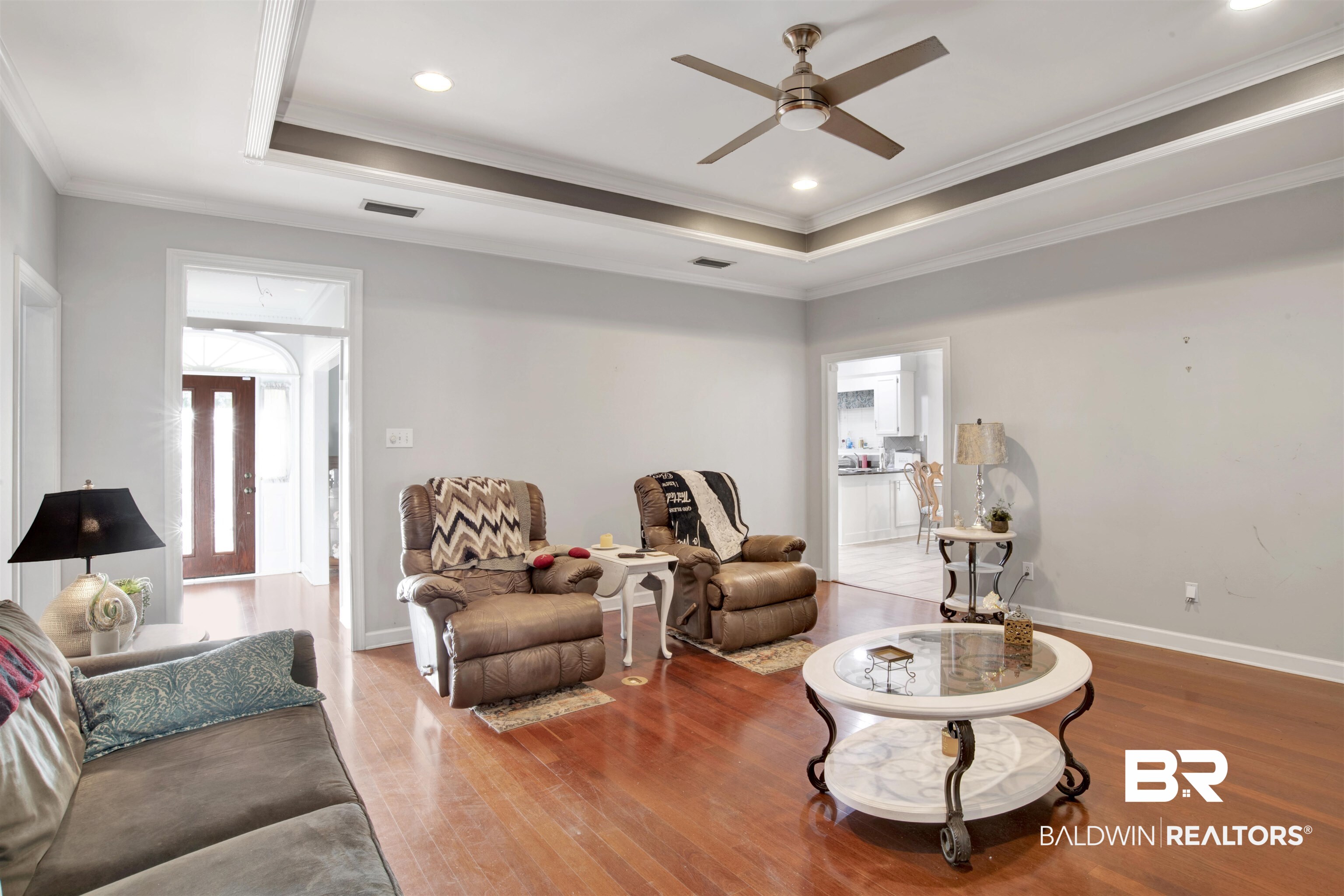 445 Wedgefield Drive South Mobile, AL 36608 - Photo 7 of 36 Living room featuring a raised ceiling, crown molding, hardwood / wood-style floors, and ceiling fan