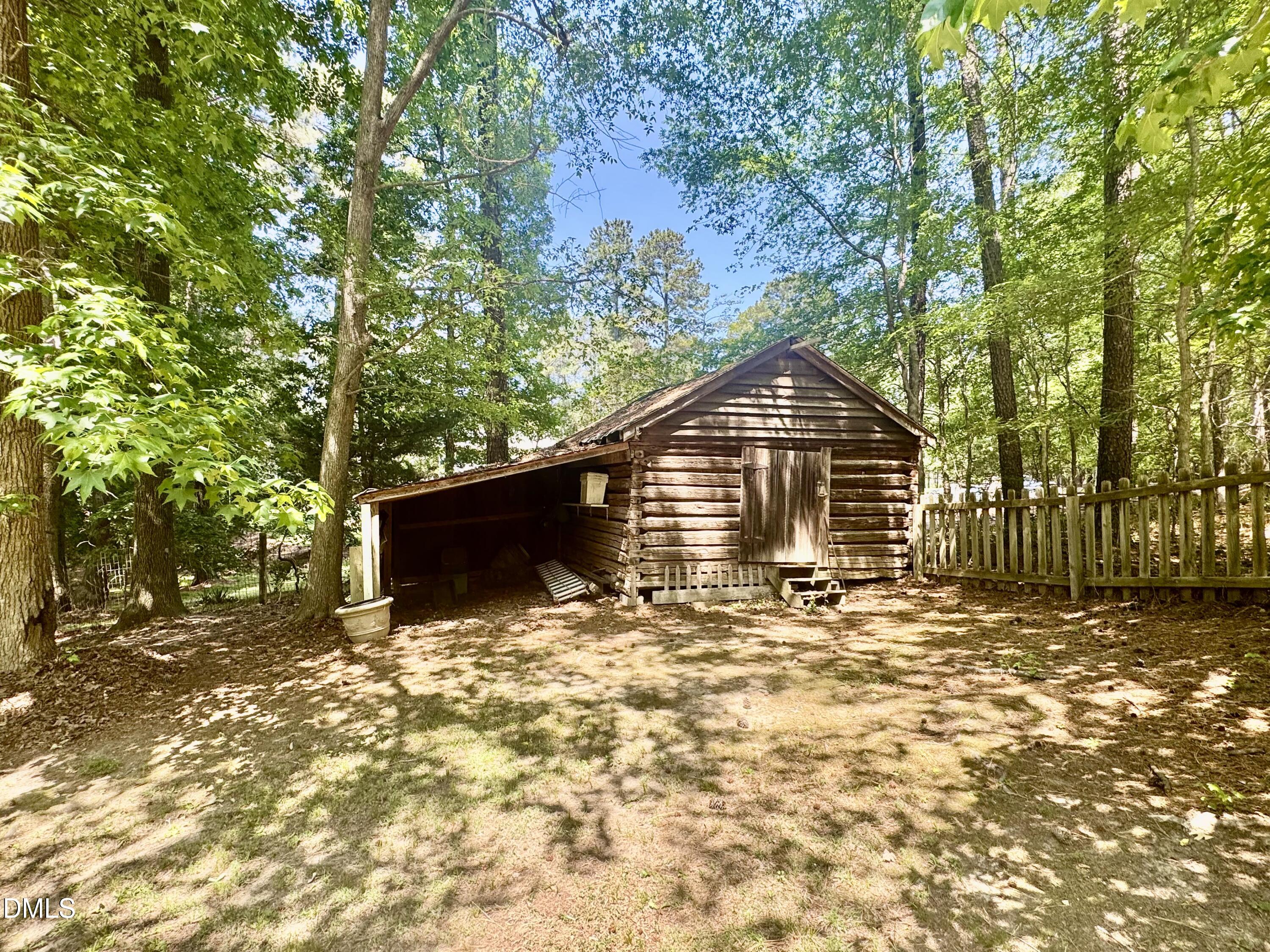 84 Wintergreen Road Henderson, NC 27537 - Photo 45 of 49 a backyard of a house with table and chairs