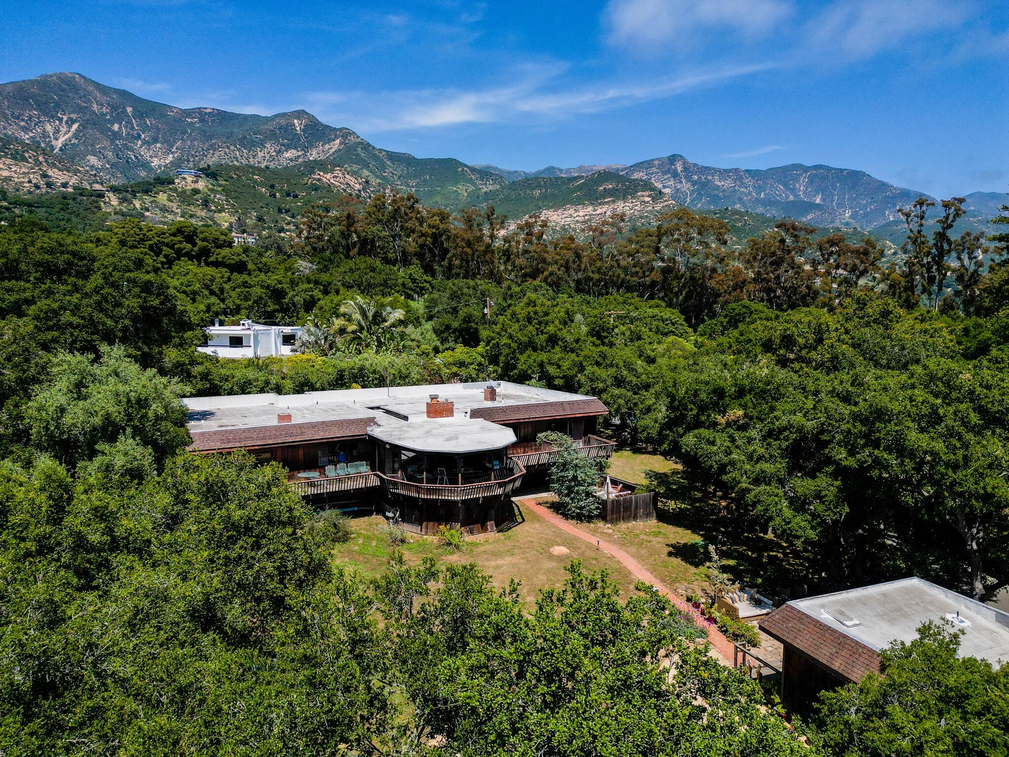 a view of a backyard with sitting area