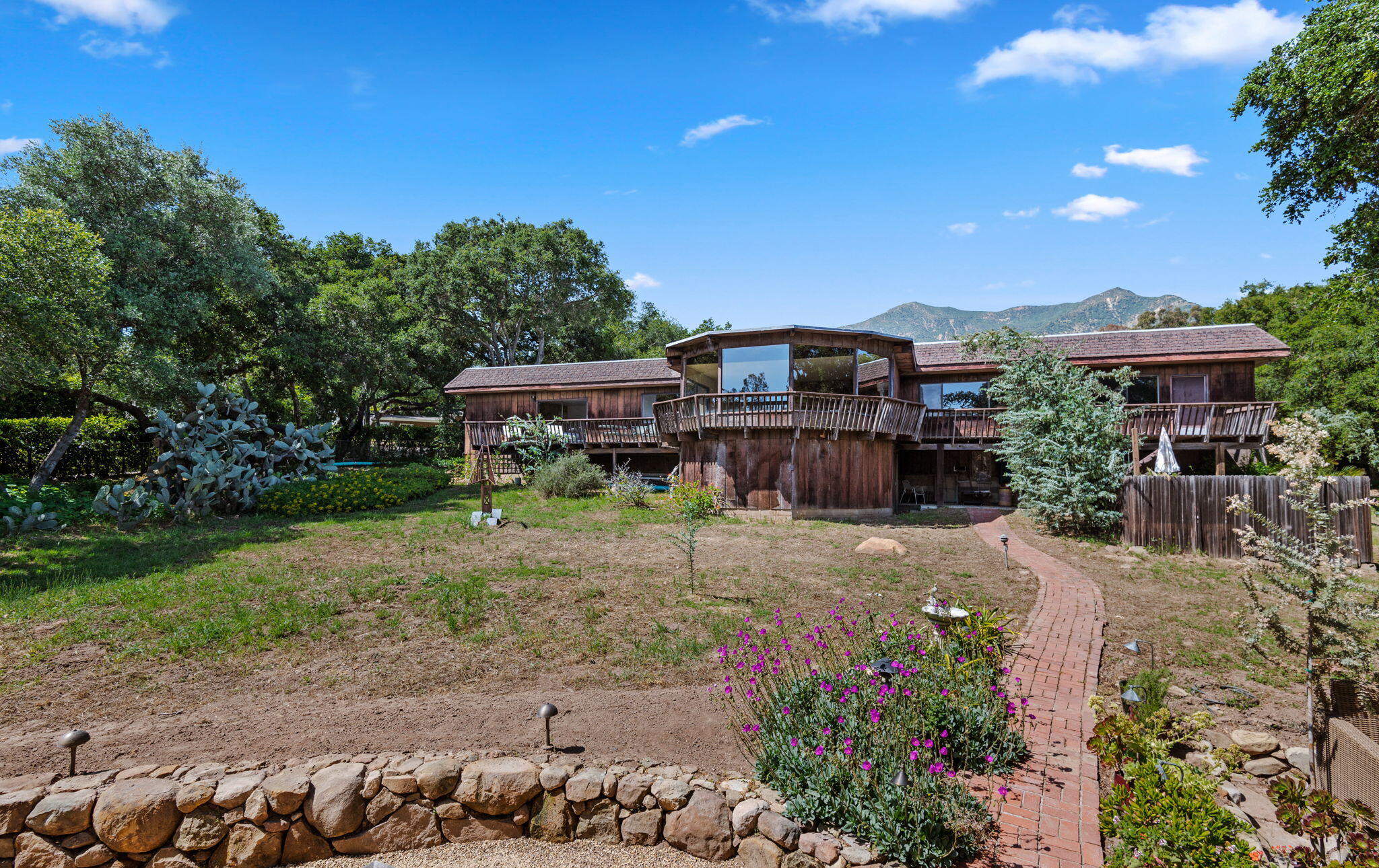 756 Hot Springs Road Montecito, CA 93108 - Photo 5 of 32 a view of a house with a backyard and a patio