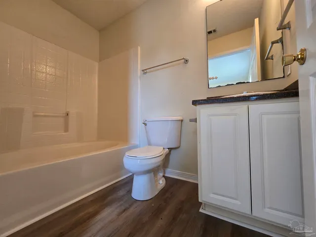 a bathroom with a toilet a sink and bathtub