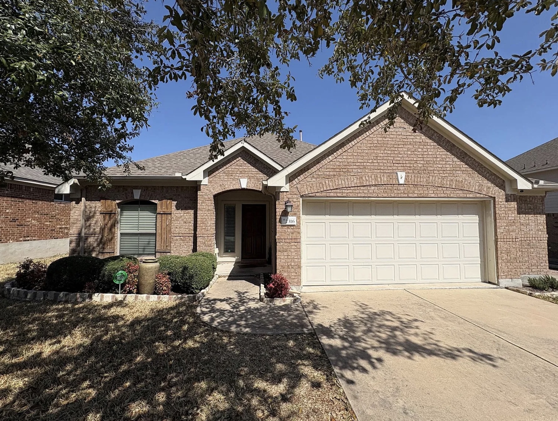 2316 Dovetail Street Pflugerville, TX 78660 - Photo 1 of 2 a front view of a house with a yard and garage