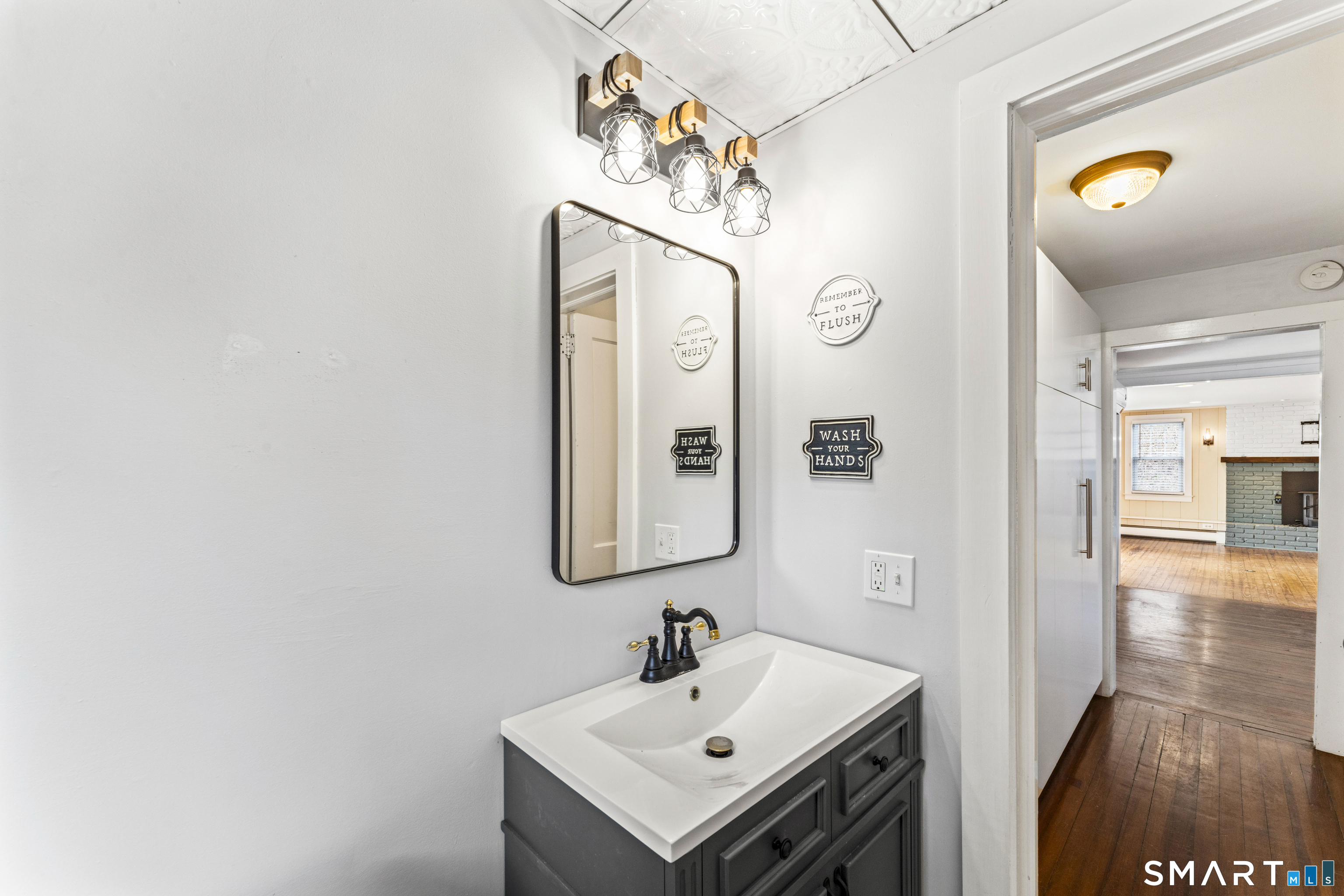 74 Middle Quarter Road Woodbury, CT 06798 - Photo 14 of 40 a bathroom with a sink and a mirror