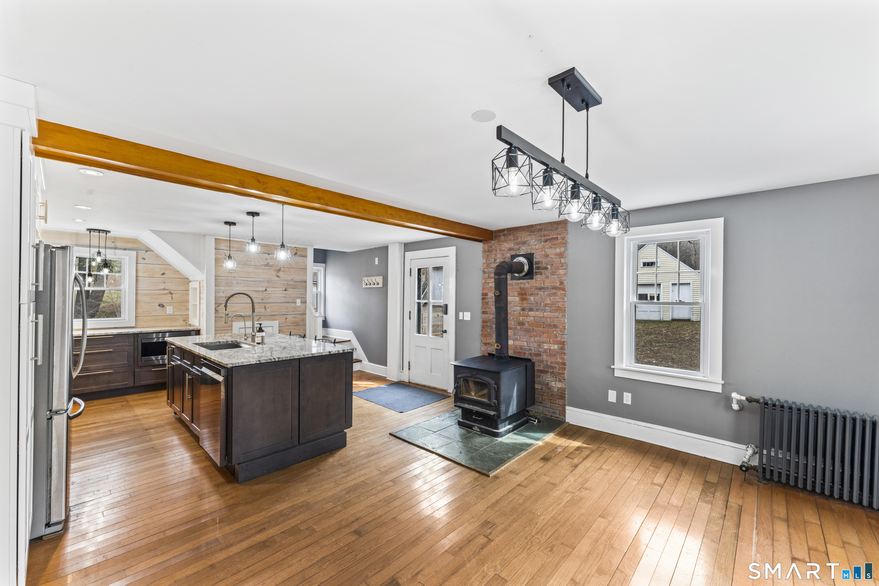74 Middle Quarter Road Woodbury, CT 06798 - Photo 15 of 40 a view of living room kitchen with stove and wooden floor
