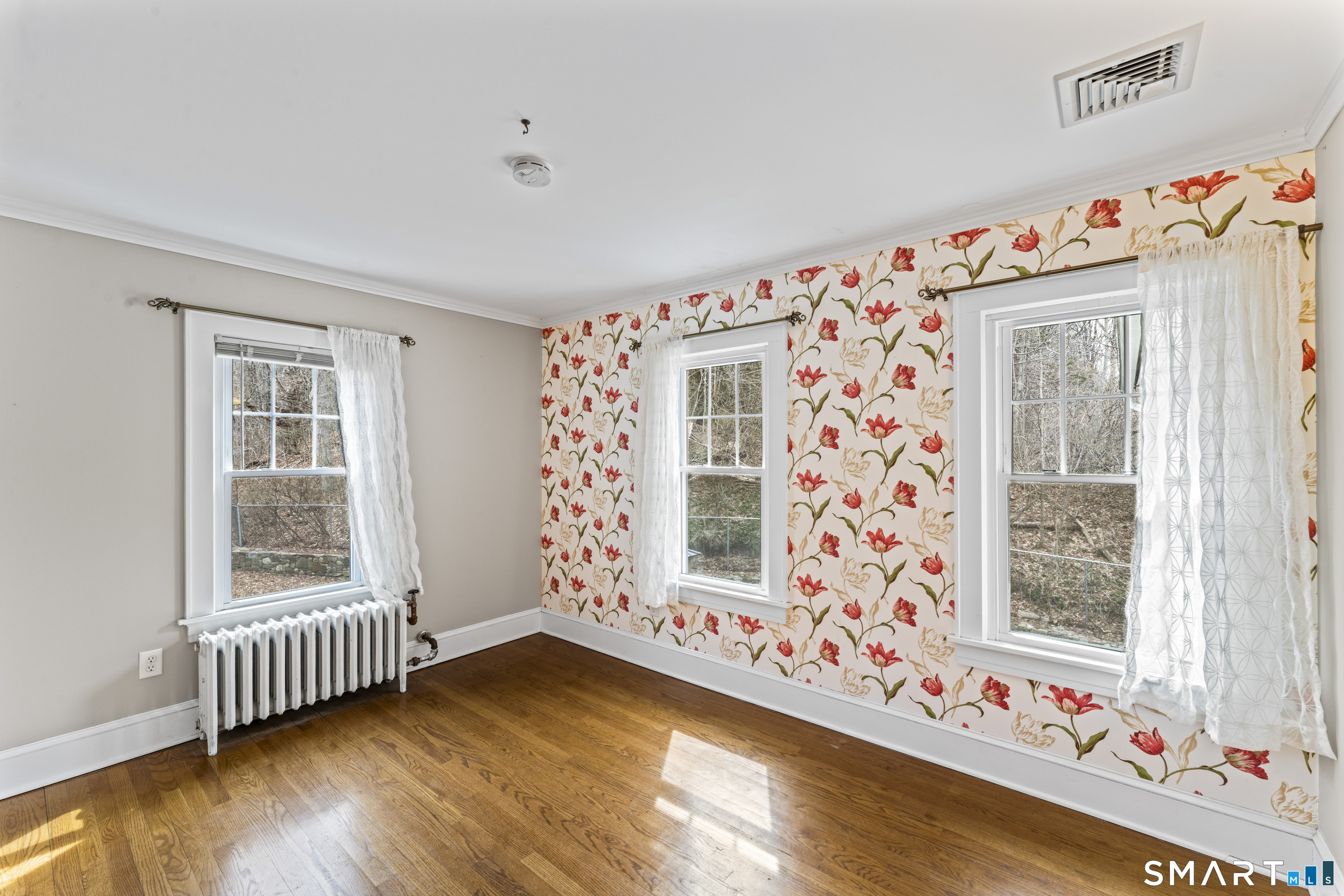 74 Middle Quarter Road Woodbury, CT 06798 - Photo 30 of 40 a view of an empty room with window and wooden floor