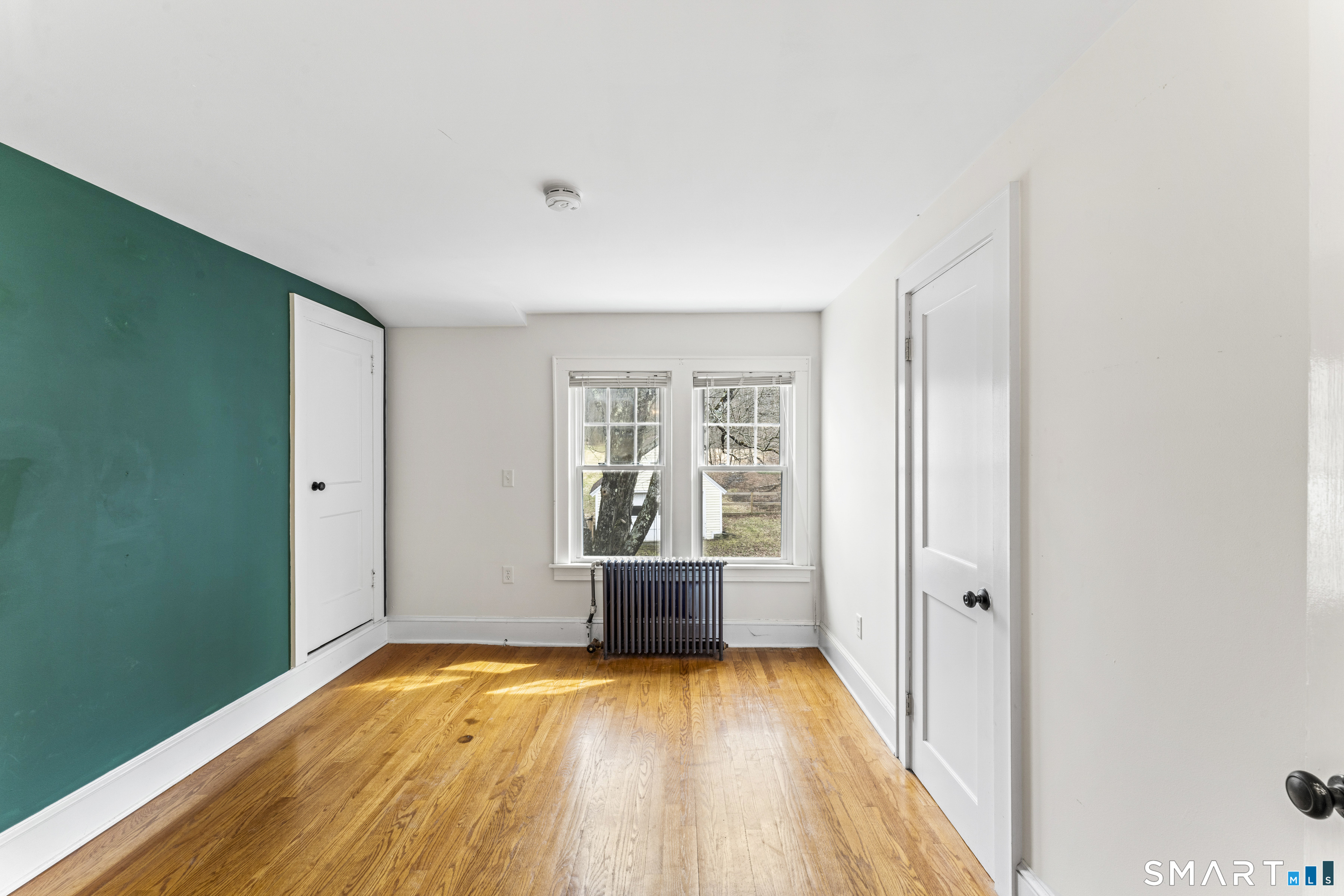 74 Middle Quarter Road Woodbury, CT 06798 - Photo 32 of 40 a view of empty room with wooden floor and fan