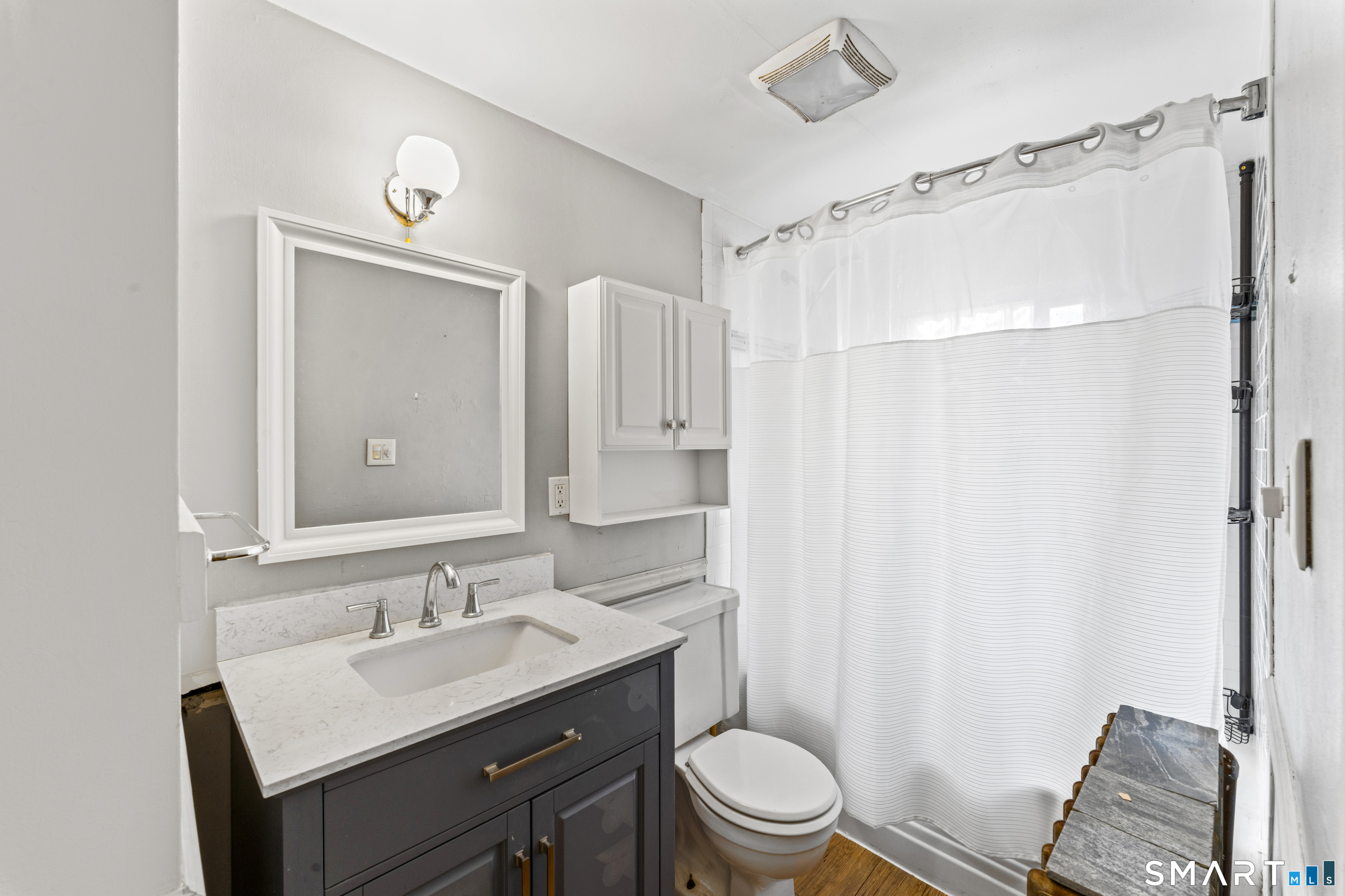 74 Middle Quarter Road Woodbury, CT 06798 - Photo 33 of 40 a bathroom with a sink toilet a mirror and shower