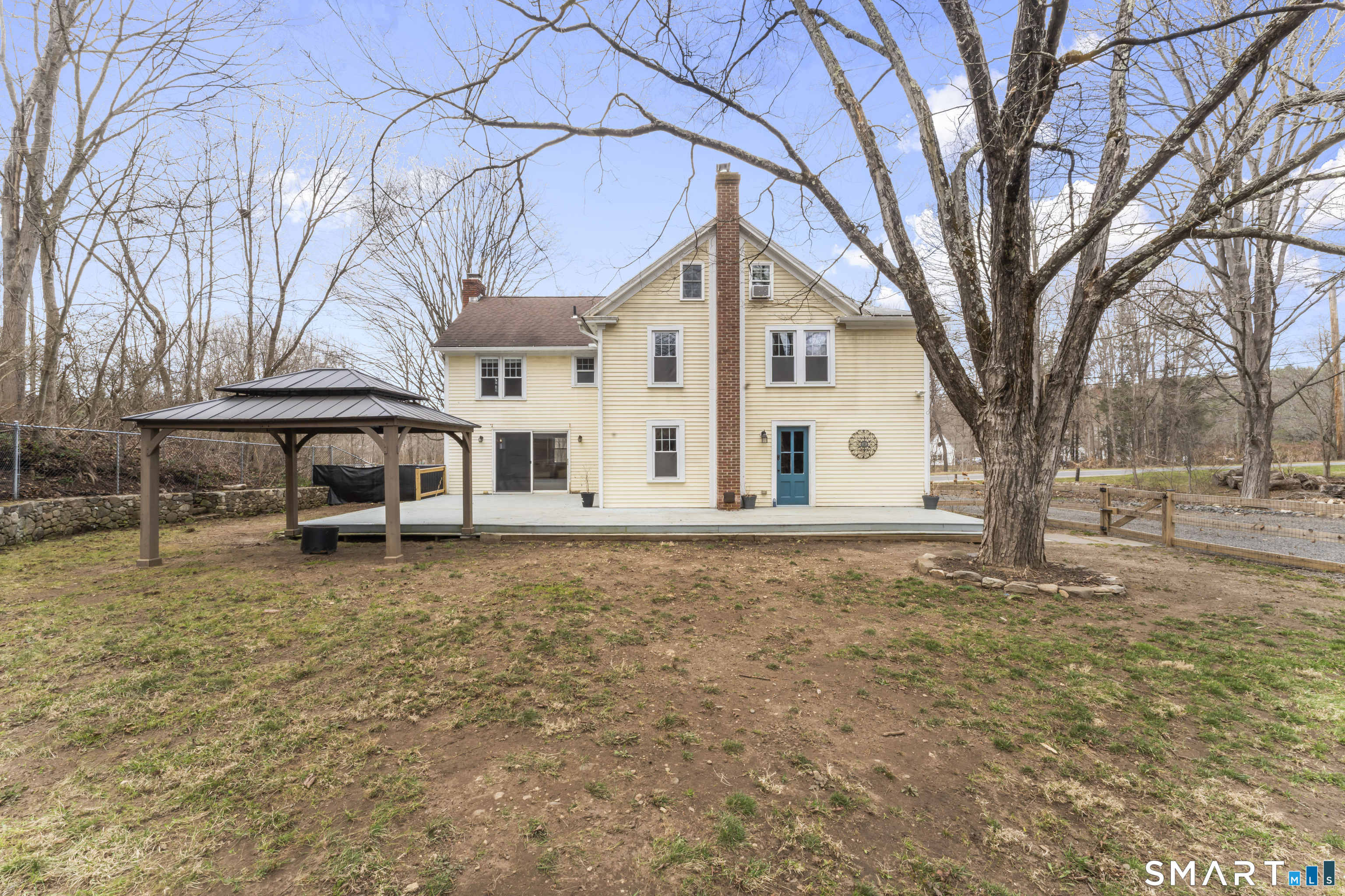 74 Middle Quarter Road Woodbury, CT 06798 - Photo 36 of 40 a white house that has a tree in front of it