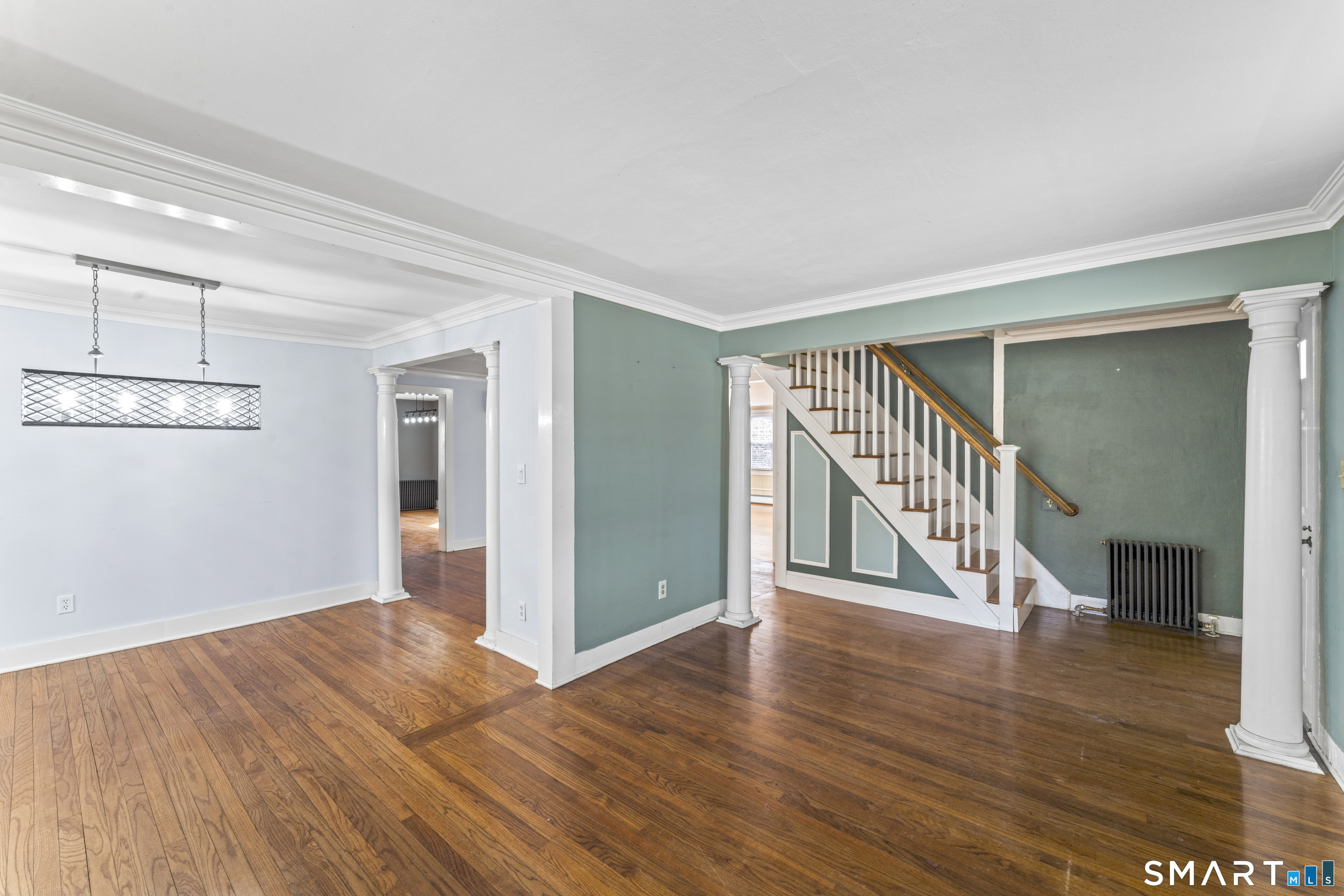 74 Middle Quarter Road Woodbury, CT 06798 - Photo 4 of 40 a view of a big room with wooden floor and windows