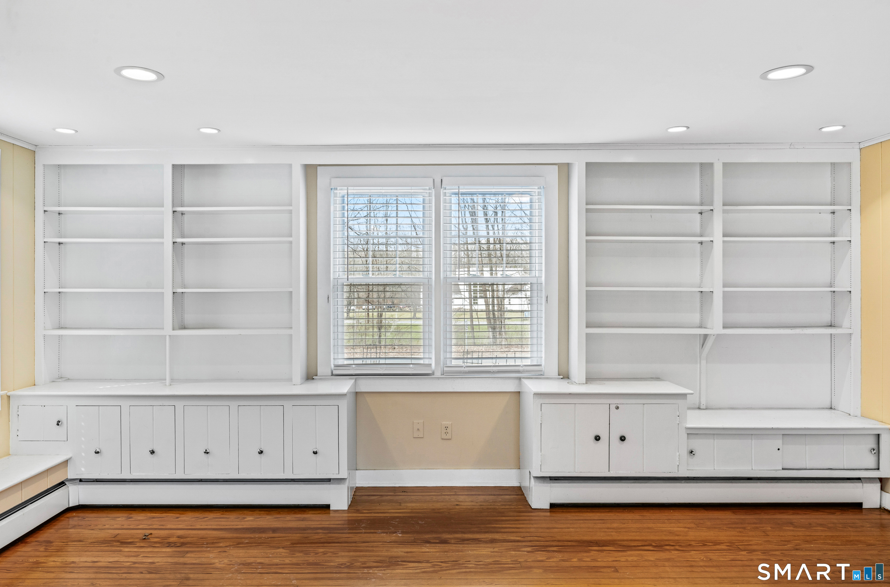 74 Middle Quarter Road Woodbury, CT 06798 - Photo 7 of 40 a view of an empty room with wooden floor and cabinet