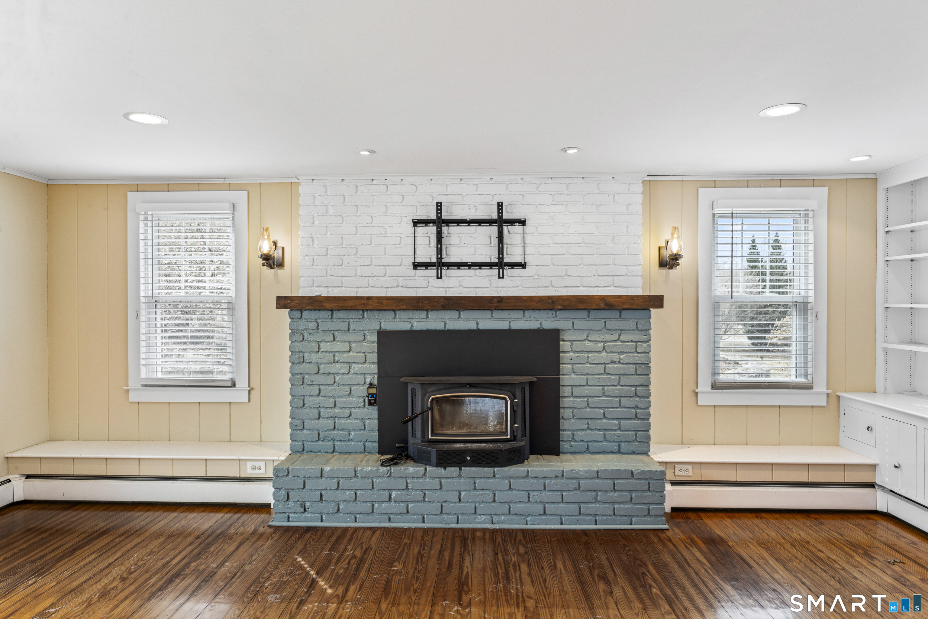 74 Middle Quarter Road Woodbury, CT 06798 - Photo 8 of 40 a living room with a fireplace and wooden floor