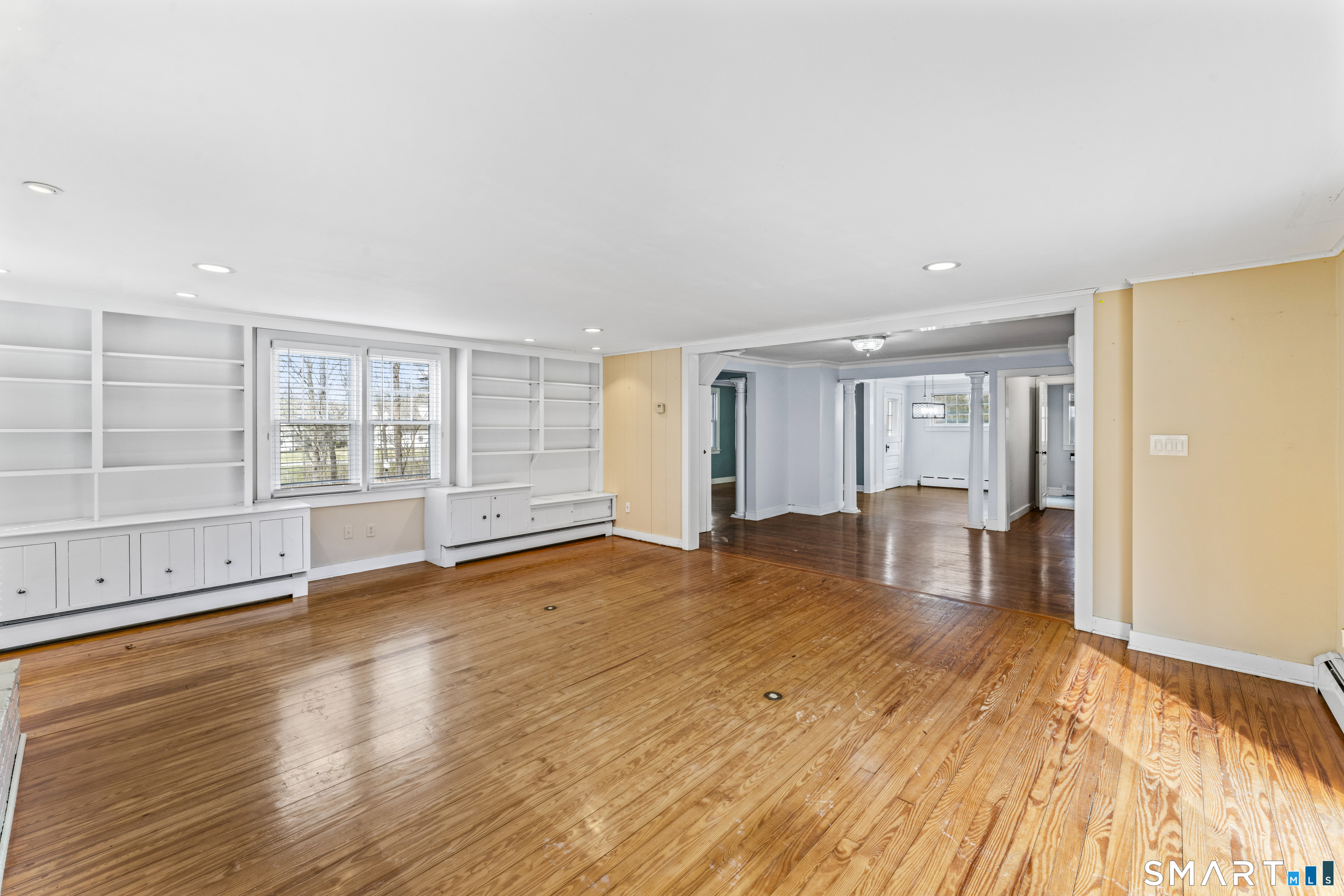 74 Middle Quarter Road Woodbury, CT 06798 - Photo 9 of 40 a view of an empty room with a window and wooden floor