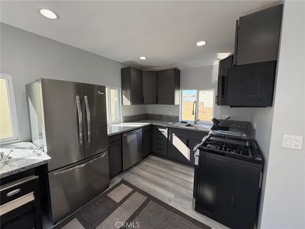 a kitchen with a refrigerator stove and sink