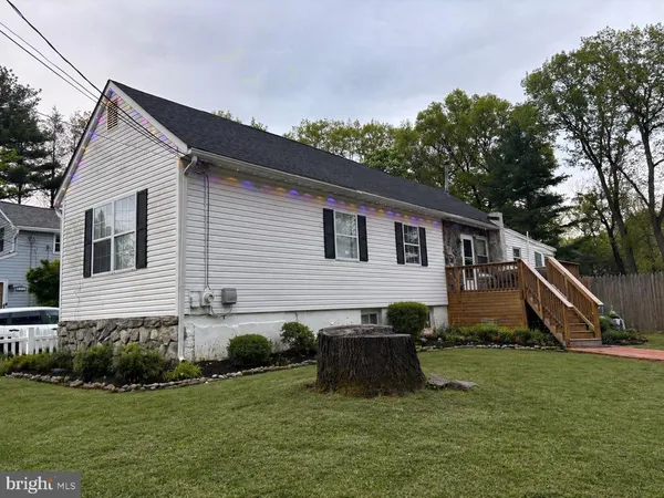 a view of a house with a yard and sitting area