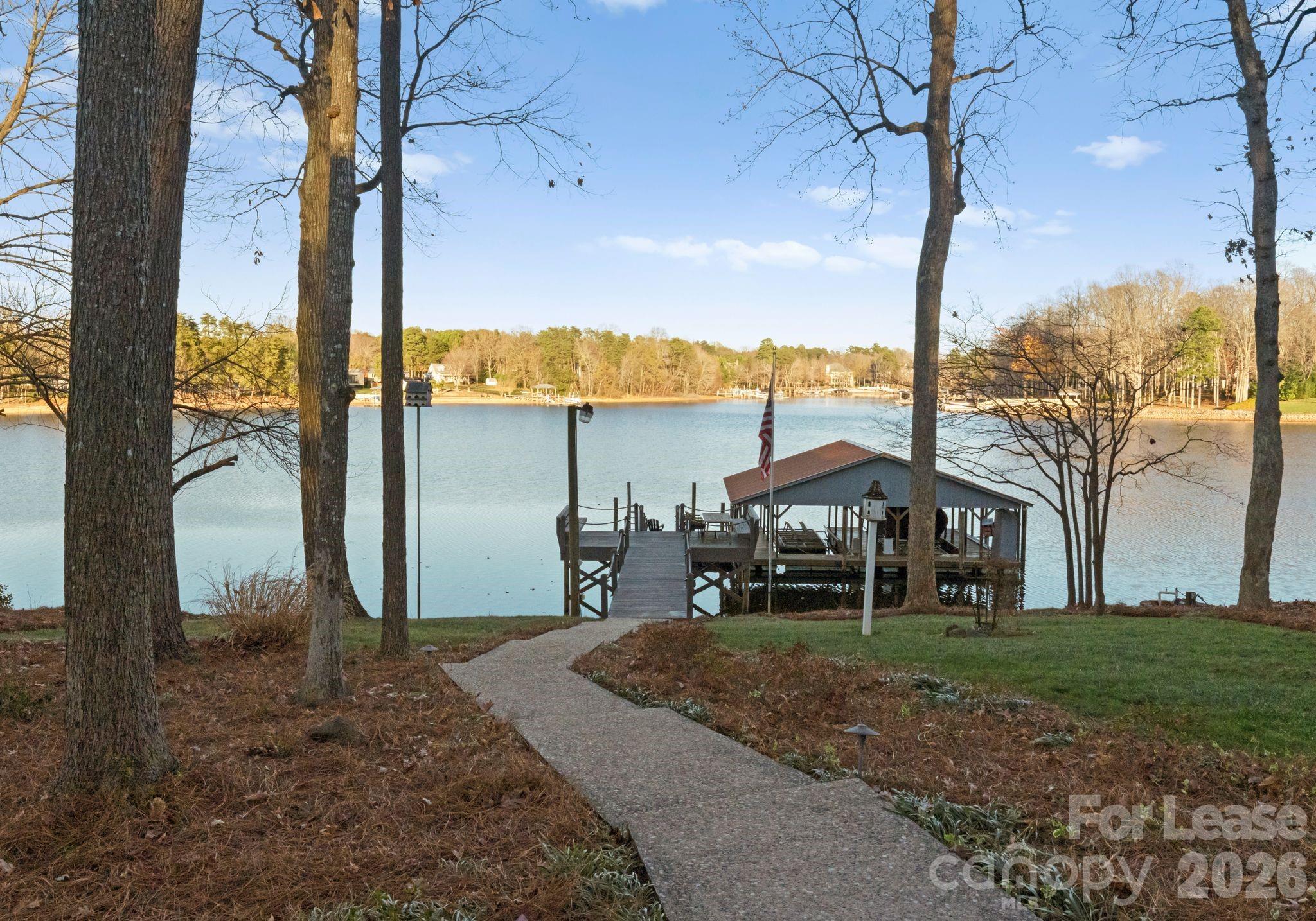 19709 Stough Farm Road Cornelius, NC 28031 - Photo 31 of 48 a front view of a house with yard patio and lake view