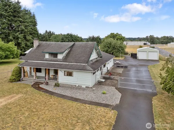 an aerial view of a house with swimming pool and furniture