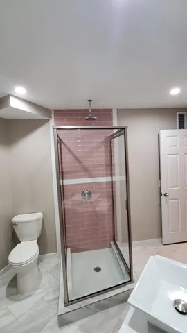 a bathroom with a shower and toilet