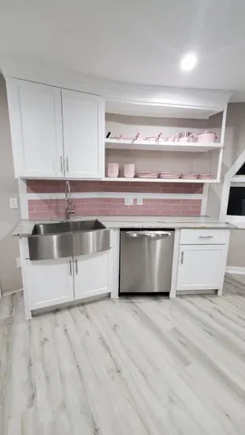 a view of a kitchen with a stove and a sink
