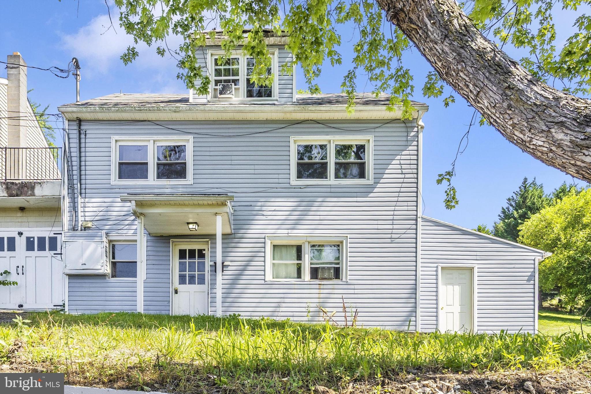 214 Jackson Street Hancock, MD 21750 - Photo 1 of 40 a view of a house with a small yard and plants