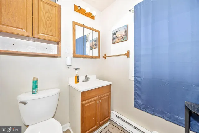 a white toilet sitting next to a bathroom sink