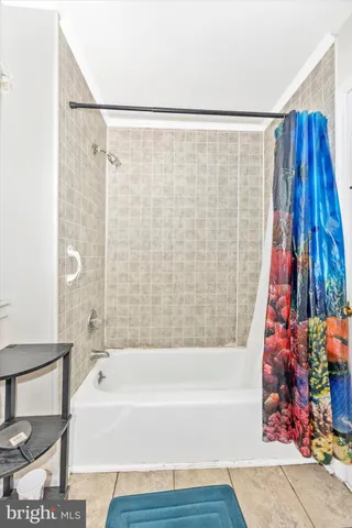 a bathroom with a bathtub and shower