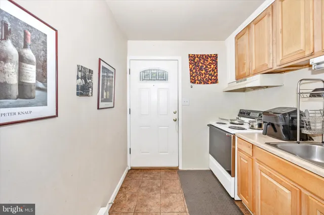 a kitchen with stainless steel appliances granite countertop a refrigerator and a stove
