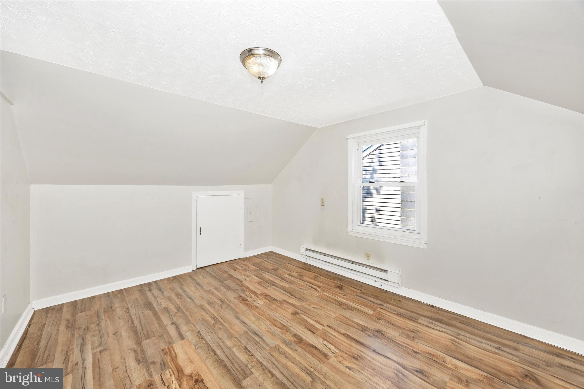 214 Jackson Street Hancock, MD 21750 - Photo 21 of 40 an empty room with wooden floor and windows