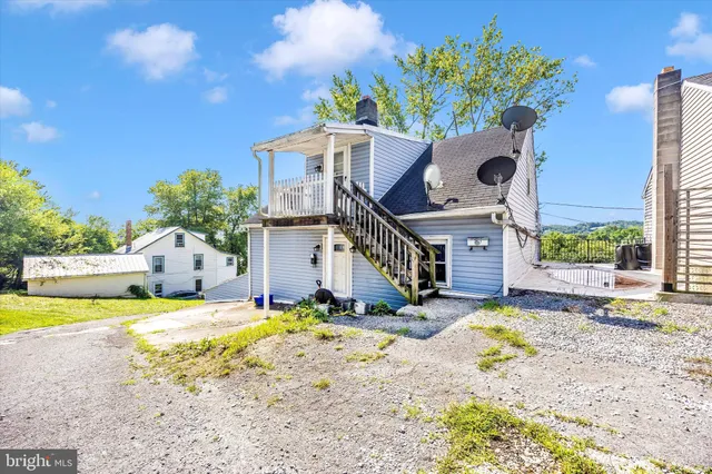a front view of a house with a yard and a pond