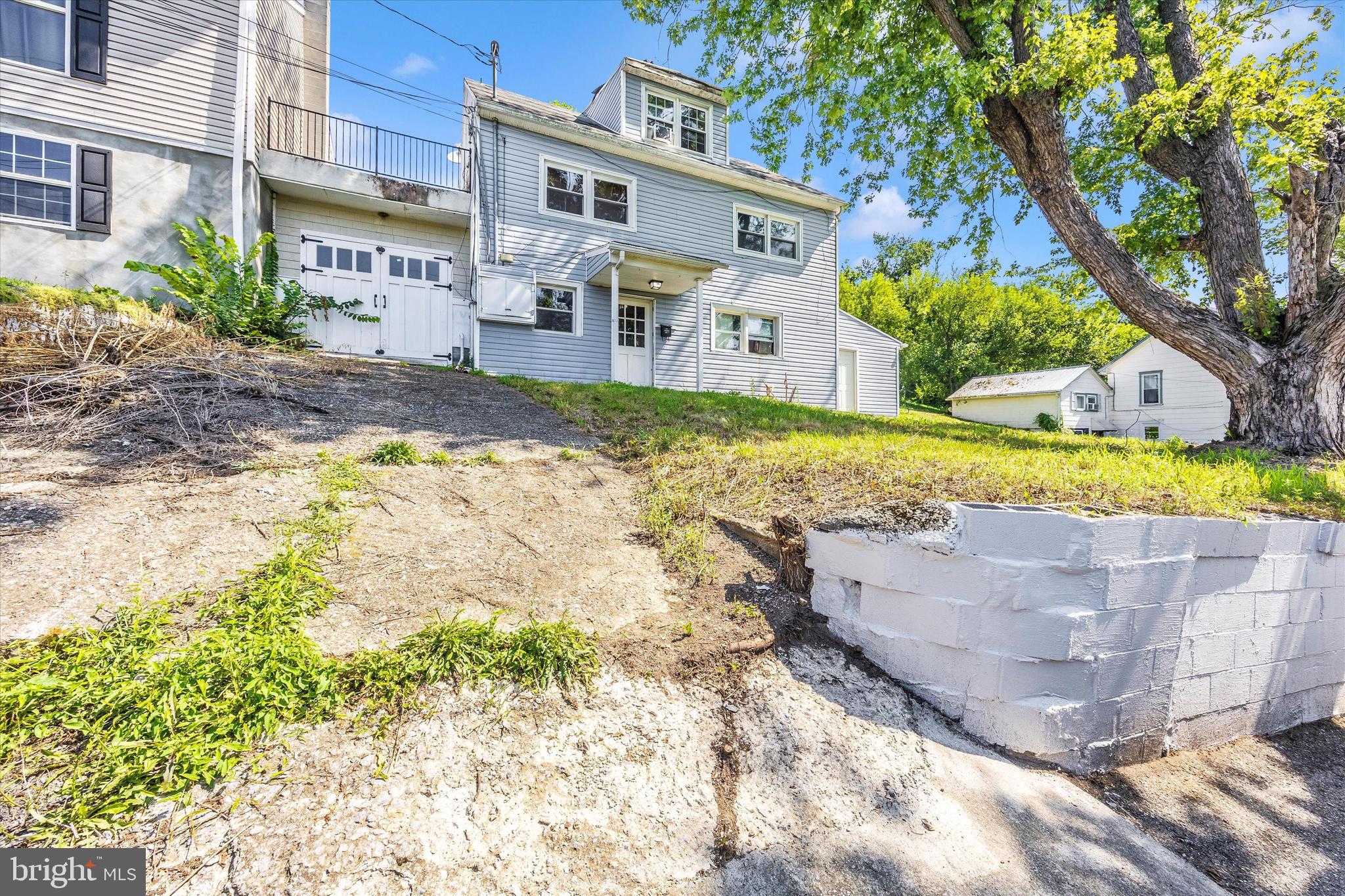 214 Jackson Street Hancock, MD 21750 - Photo 30 of 40 a front view of a house with a yard and a pond
