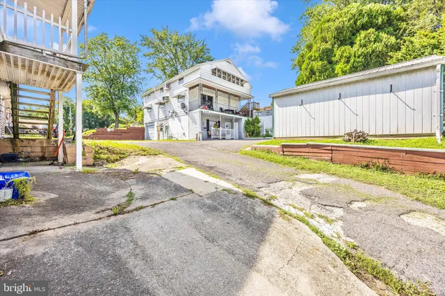 a view of a house with backyard and sitting area