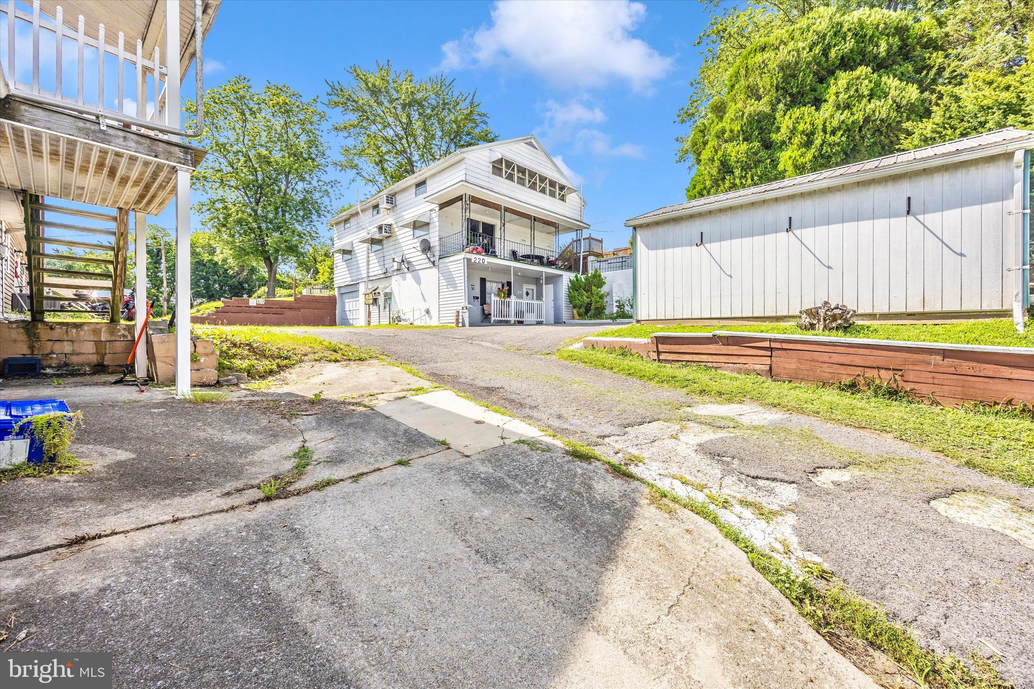 214 Jackson Street Hancock, MD 21750 - Photo 32 of 40 a front view of a house with a yard and a garage
