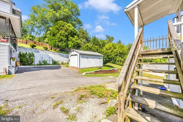 a front view of a house with a yard and potted plants