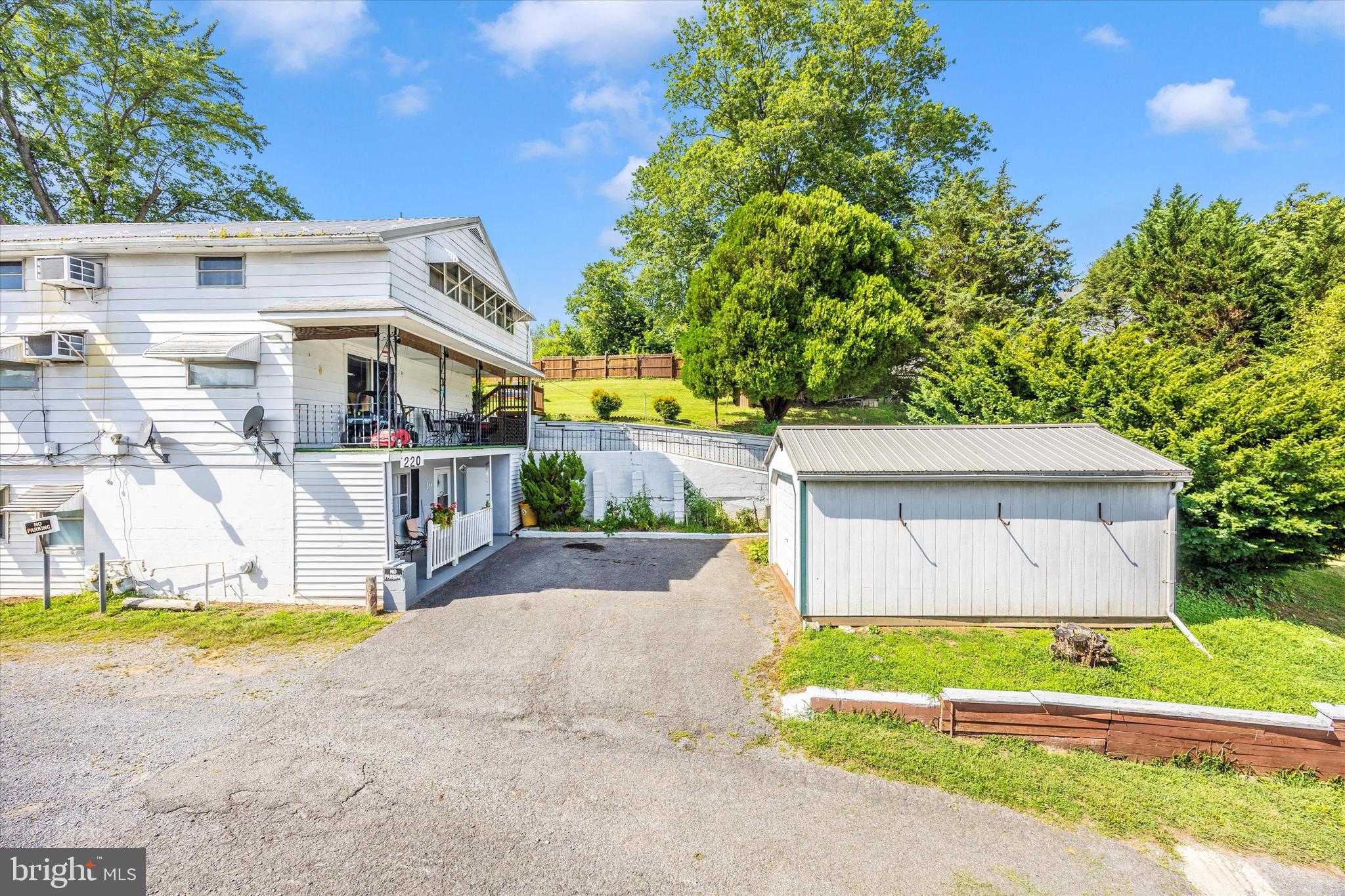 214 Jackson Street Hancock, MD 21750 - Photo 35 of 40 a front view of a house with a yard and potted plants