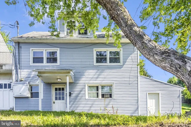 a view of a house with a yard and tree s