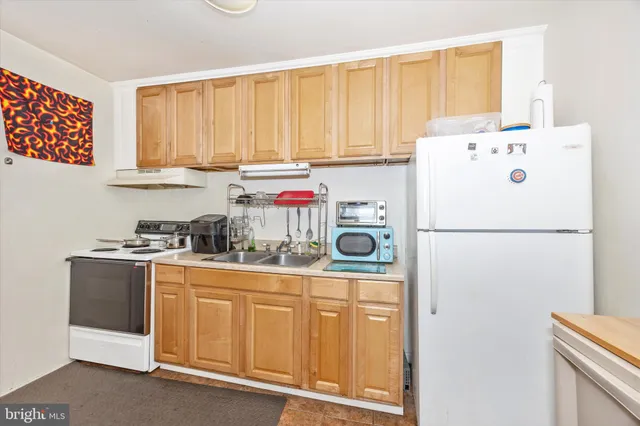 a kitchen with a white cabinets and white appliances