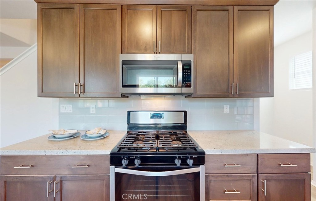 24320 Insignia Drive Menifee, CA 92584 - Photo 20 of 65 a stove top oven sitting inside of a kitchen
