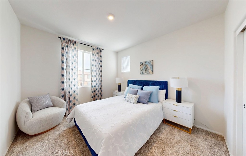 24320 Insignia Drive Menifee, CA 92584 - Photo 28 of 65 a bedroom with a bed a couch and a window
