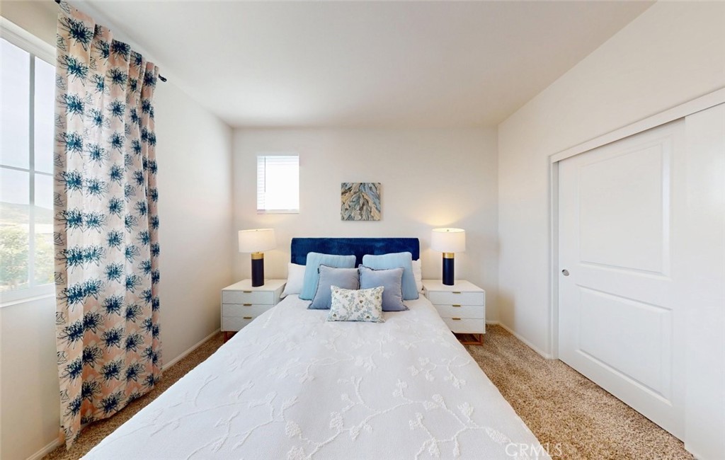 24320 Insignia Drive Menifee, CA 92584 - Photo 29 of 65 a bed room with a bed and a lamp